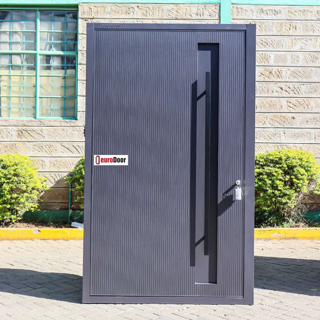 gray titanium pivot door design with a long vertical handle